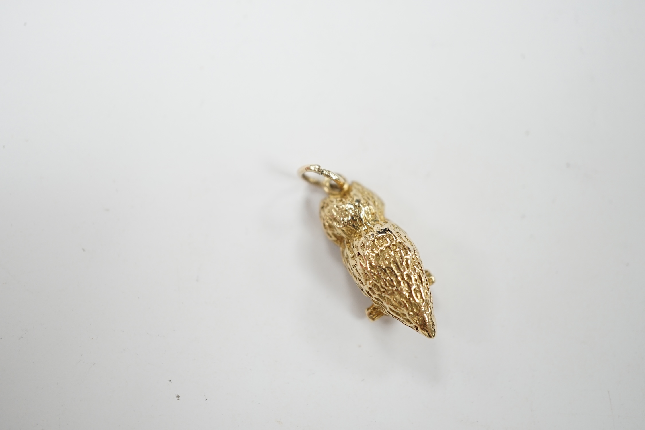 A 1960's 9ct gold and two stone gem set owl on a perch pendant, 26mm, gross weight 5 grams. Condition - good